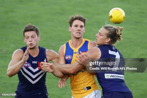 Jack Redden of the Eagles is tackled by Nat Fyfe of the Dockers during the JLT Community Series AFL match between the Fremantle Dockers and the West...