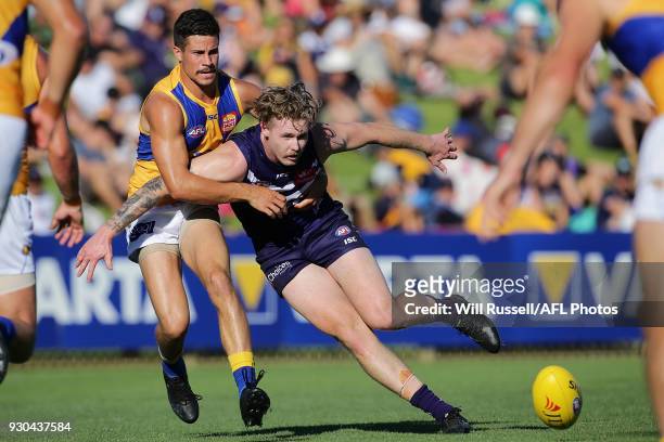 Cam McCarthy of the Dockers is tackled by Liam Duggan of the Eagles during the JLT Community Series AFL match between the Fremantle Dockers and the...