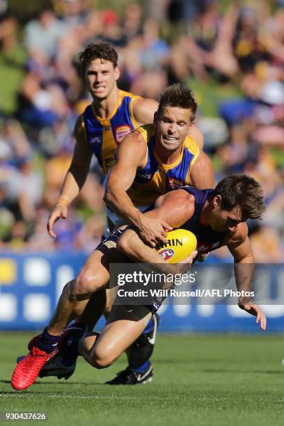 Lee Spurr of the Dockers is tackled by Mark LeCras of the Eagles during the JLT Community Series AFL match between the Fremantle Dockers and the West...