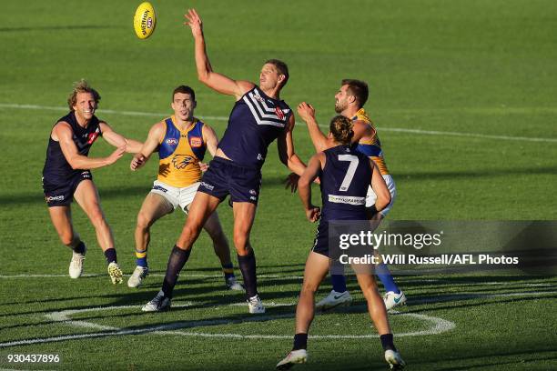 Aaron Sandilands of the Dockers taps the ball out the centre square during the JLT Community Series AFL match between the Fremantle Dockers and the...