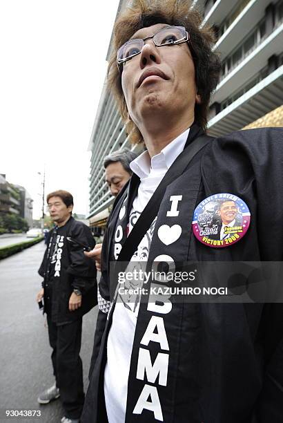 Residents from the Japanese town of Obama City in Fukui Prefecture wear 'happi' coats and T-shirts emblazoned with "I Love Obama" as they wait from...