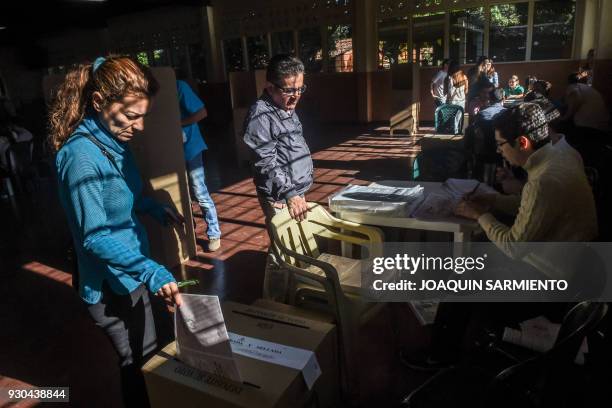 People vote at a polling station in Medellin, Antioquia Department, during parliamentary elections in Colombia on March 11, 2018. Colombians went to...