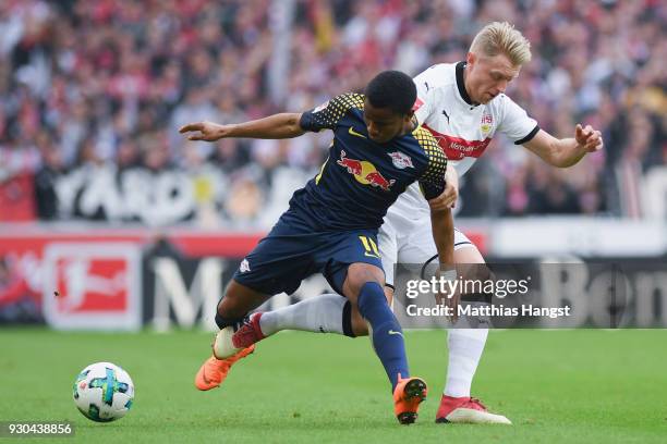 Ademola Lookman of Leipzig is challenged by Andreas Beck of Stuttgart during the Bundesliga match between VfB Stuttgart and RB Leipzig at...