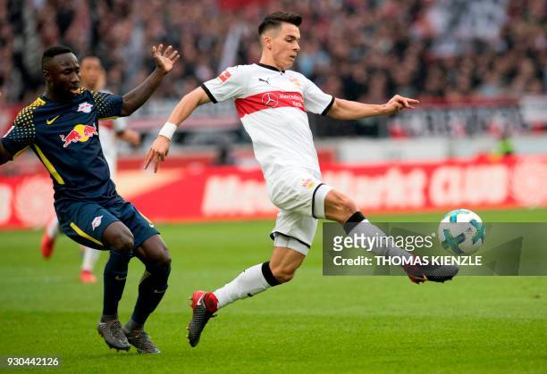 Stuttgart's Midfielder Erik Thommy and Leipzig's Guinean midfielder Naby Keita vie for the ball during the German first division Bundesliga football...