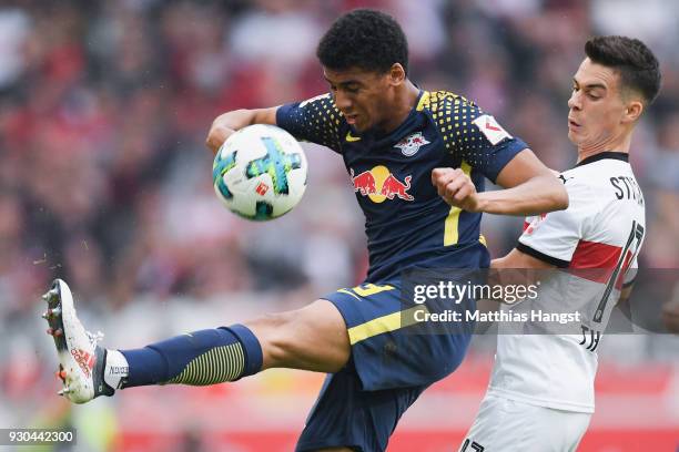 Bernardo of Leipzig is challenged by Erik Thommy of Stuttgart during the Bundesliga match between VfB Stuttgart and RB Leipzig at Mercedes-Benz Arena...