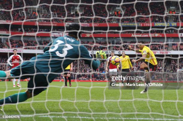 Arsenal goalkeeper Petr Cech saves a penalty kick taken by Troy Deeney of Watford during the Premier League match between Arsenal and Watford at...
