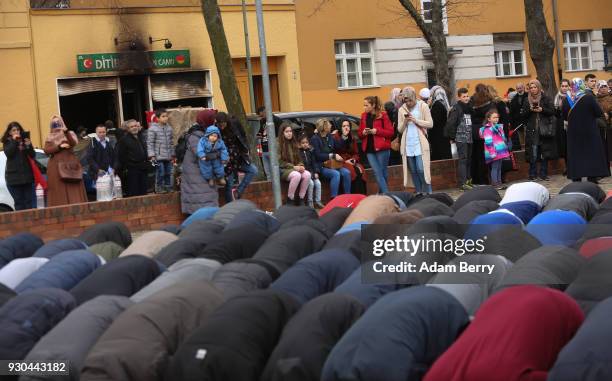 Koca Sinan Camii mosque congregation members pray outside, having nowhere to do so inside their mosque the day after a fire there the previous night,...