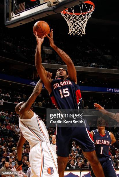 Al Horford of the Atlanta Hawks goes to the basket under pressure against Raja Bell of the Charlotte Bobcats during the game on November 6, 2009 at...