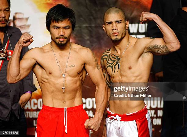 Manny Pacquiao and WBO welterweight champion Miguel Cotto stand next to each other during the weigh-in for their bout at the MGM Grand Garden Arena...