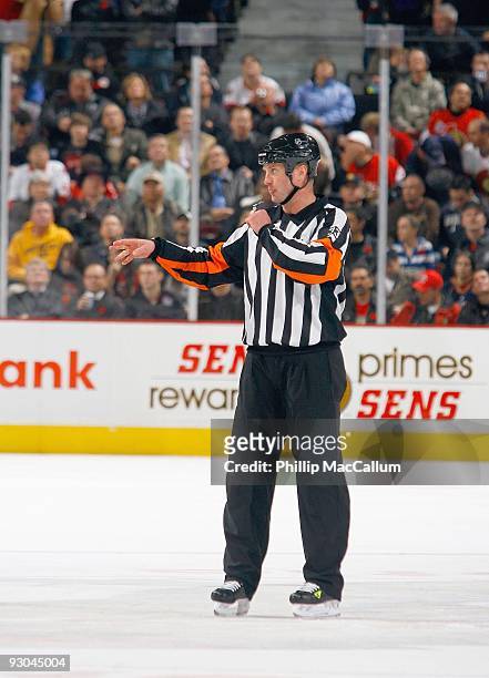 Referee Kevin Pollack makes a call during the game between the Edmonton Oilers and the Ottawa Senators in a game at Scotiabank Place on November 10,...