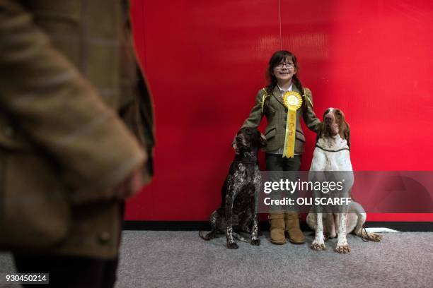 Kiara, aged 6, poses for a photograph with her dogs, on the left, "Madison" a German Short Haired Pointer and "Fenn" the Bracco Italiano, on the...