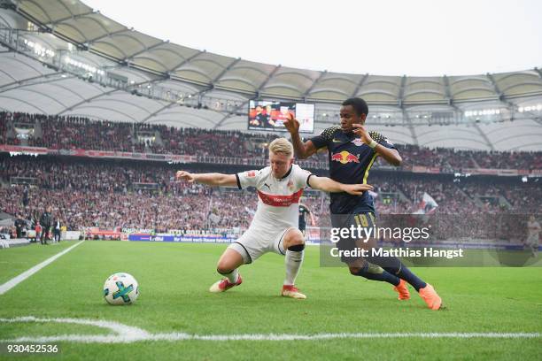 Andreas Beck of Stuttgart is challenged by Ademola Lookman of Leipzig during the Bundesliga match between VfB Stuttgart and RB Leipzig at...