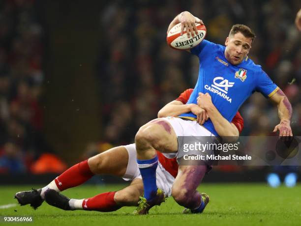 Tommaso Benvenuti of Italy is tackled by Owen Watkin of Wales during the NatWest Six Nations match between Wales and Italy at Principality Stadium on...