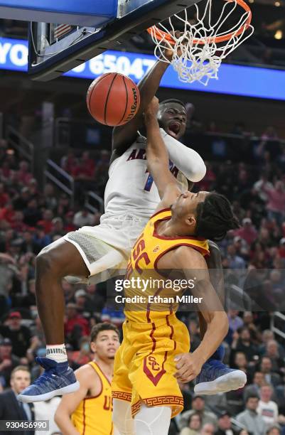 Rawle Alkins of the Arizona Wildcats dunks against Elijah Stewart of the USC Trojans during the championship game of the Pac-12 basketball tournament...