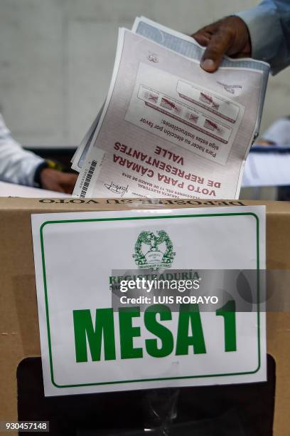 Man votes at a polling station in Cali, Valle del Cauca Department, during parliamentary elections in Colombia on March 11, 2018. Colombians went to...