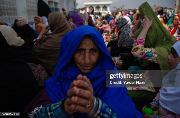 An elderly Kashmiri Muslim woman devotee prays, at Hazratbal shrine to mark the anniversary of Hazrat Abu Bakr Siddiq, the senior companion and the...