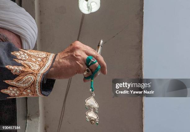 Kashmiri Muslim cleric displays the holy relic believed to be the whisker from the beard of the Prophet Mohammed, at Hazratbal shrine to mark the...