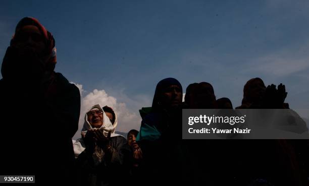 Kashmiri Muslim women devotees look towards a cleric displaying the holy relic believed to be the whisker from the beard of the Prophet Mohammed, at...