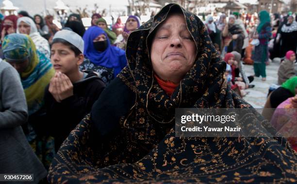 Kashmiri Muslim woman devotee prays, at Hazratbal shrine to mark the anniversary of Hazrat Abu Bakr Siddiq, the senior companion and the...