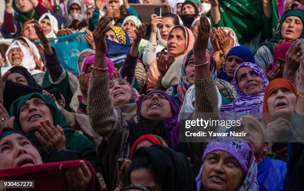 Kashmiri Muslim women devotees look towards a cleric displaying the holy relic believed to be the whisker from the beard of the Prophet Mohammed, at...