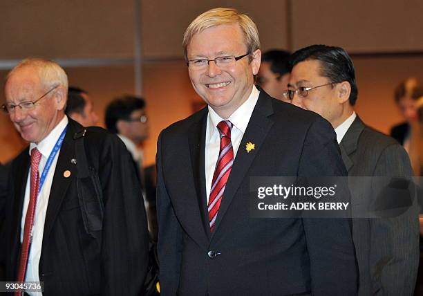 Australian Prime Minister Kevin Rudd smiles as he walks with officials after addressing a CEO summit in Singapore on November 14 on the sidelines of...