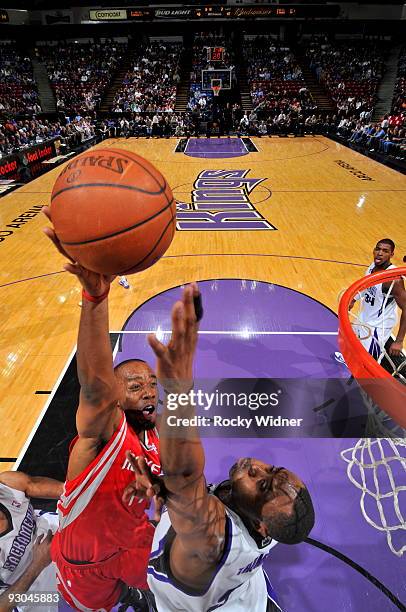 Carl Landry of the Houston Rockets takes the ball to the basket against Kenny Thomas of the Sacramento Kings on November 13, 2009 at ARCO Arena in...