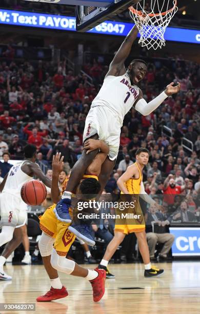 Rawle Alkins of the Arizona Wildcats dunks against Elijah Stewart of the USC Trojans during the championship game of the Pac-12 basketball tournament...