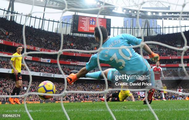 Henrikh Mkhitaryan scores Arsenal's 3rd goal past Orestis Karnezis of Watford during the Premier League match between Arsenal and Watford at Emirates...