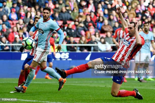 Atletico Madrid's Uruguayan defender Diego Godin contols the ball next to Celta Vigo's Spanish defender Sergi Gomez during the Spanish league...