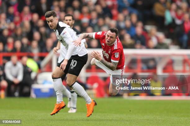 Tom Lawrence of Derby County fouls Lee Tomlin of Nottingham Forest during the Sky Bet Championship match between Nottingham Forest and Derby County...