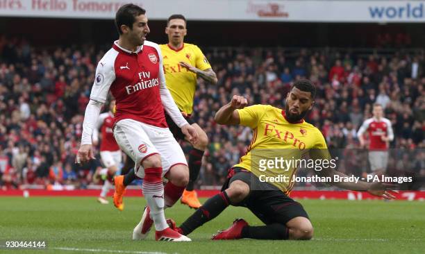 Arsenal's Henrikh Mkhitaryan is tackled inside the box by Watford's Adrian Mariappa but no penalty is given during the Premier League match at the...
