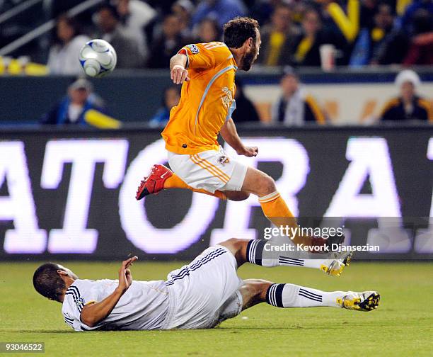 Brad Davis of the Houston Dynamo jump over the slide tackle of Omar Gonzalez of the Los Angeles Galaxy in the first half during the 2009 MLS Western...