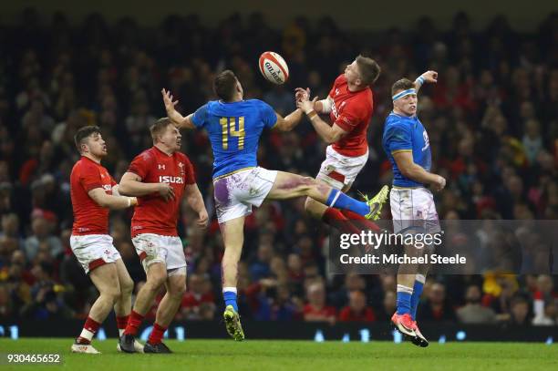 Gareth Anscombe of Wales jumps for a high ball with Tommaso Benvenuti and Giovanni Licata of Italy during the NatWest Six Nations match between Wales...