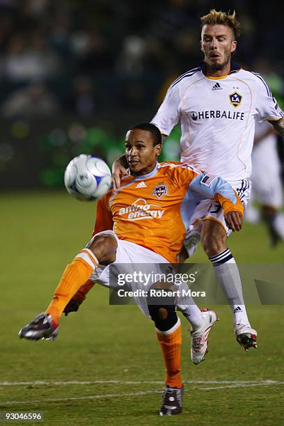 Ricardo Clark of the Houston Dynamo wins a loose ball past David Beckham of the Los Angeles Galaxy during the 2009 MLS Western Conference...
