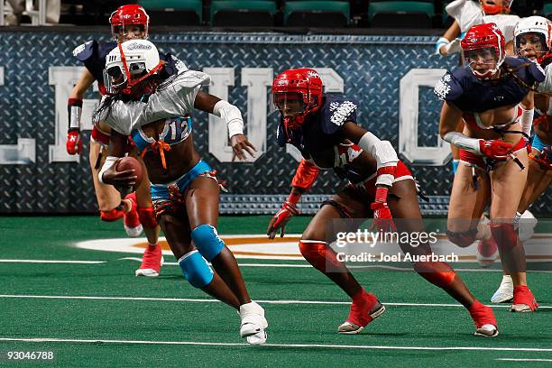 Anonka Dixon of the Miami Caliente runs with the ball while being chased by Tanyka Renee of the New York Majesty on November 13, 2009 at the...