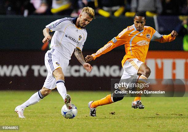 David Beckham of the Los Angeles Galaxy kicks a pass with the back of his heel against Ricardo Clark Houston Dynamo in the first half during the 2009...