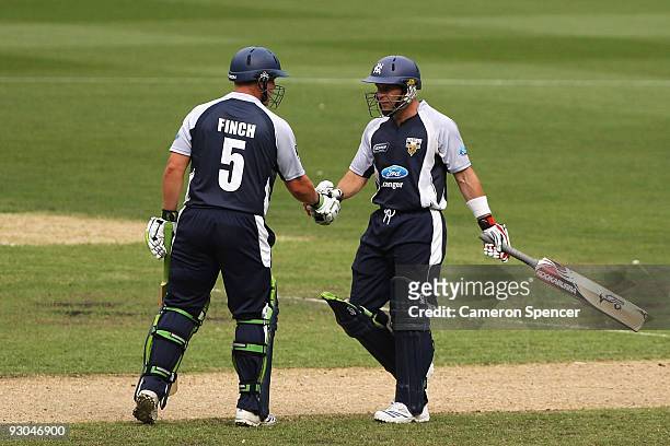 Brad Hodge of the Bushrangers is congratulated by team mate Aaron Finch after scoring a century during the Ford Ranger Cup match between the Victoria...