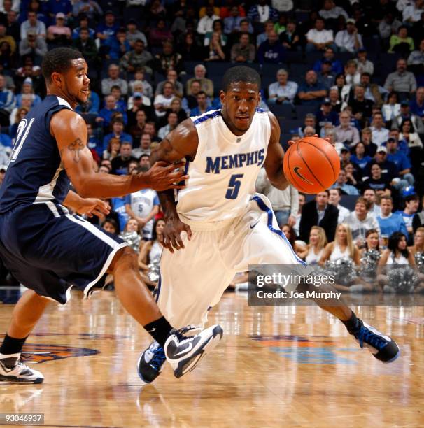 Willie Kemp of the Memphis Tigers drives with the ball against Phillip Williams of the Jackson State Tigers on November 13, 2009 at FedexForum in...