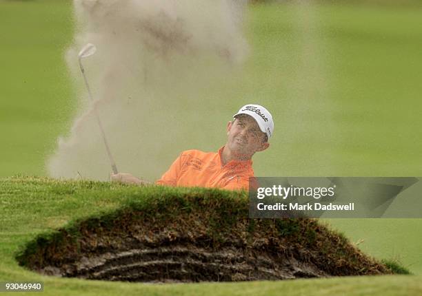 Greg Chalmers of New Zealand plays out of a bunker on the 14th hole during round three of the 2009 Australian Masters at Kingston Heath Golf Club on...
