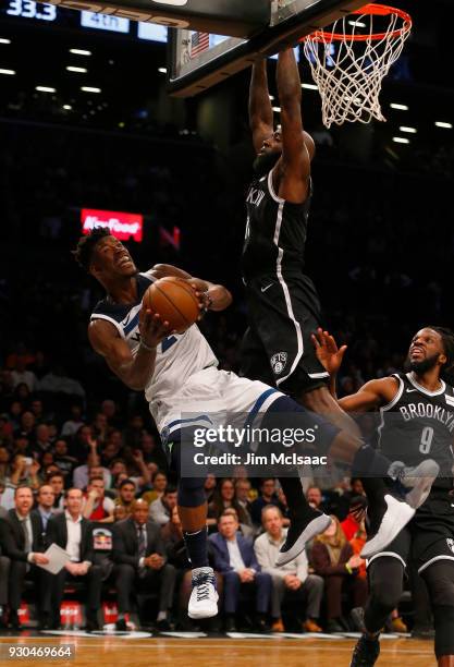 Jimmy Butler of the Minnesota Timberwolves in action against Quincy Acy of the Brooklyn Nets at Barclays Center on January 3, 2018 in the Brooklyn...