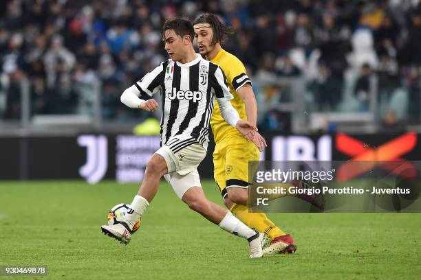 Paulo Dybala of Juventus competes for the ball with Gabriele Angella of Udinese Calcio during the serie A match between Juventus and Udinese Calcio...