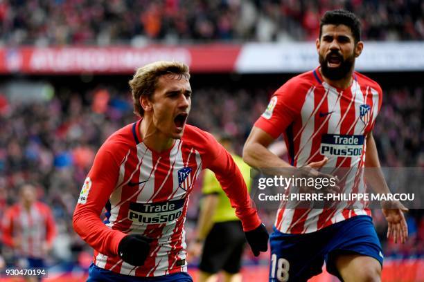 Atletico Madrid's French forward Antoine Griezmann celebrates with Atletico Madrid's Spanish forward Diego Costa after scoring a goal during the...