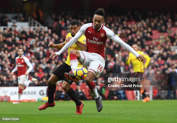 Pierre-Emerick Aubameyang of Arsenal controls the ball under pressure from Adrian Mariappa of Watford during the Premier League match between Arsenal...