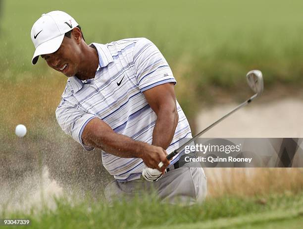 Tiger Woods of the USA plays out of a bunker on the 13th hole during round three of the 2009 Australian Masters at Kingston Heath Golf Club on...
