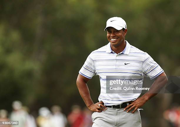 Tiger Woods of the USA smiles whilst preparing to play an approach on the 14th hole during round three of the 2009 Australian Masters at Kingston...