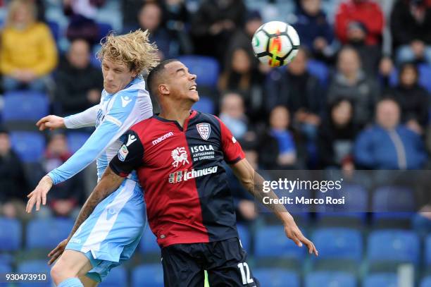 Dusan Basta of SS Lazio compete for the ball with Senna Miangue of Cagliari Calcio during the serie A match between Cagliari Calcio and SS Lazio at...