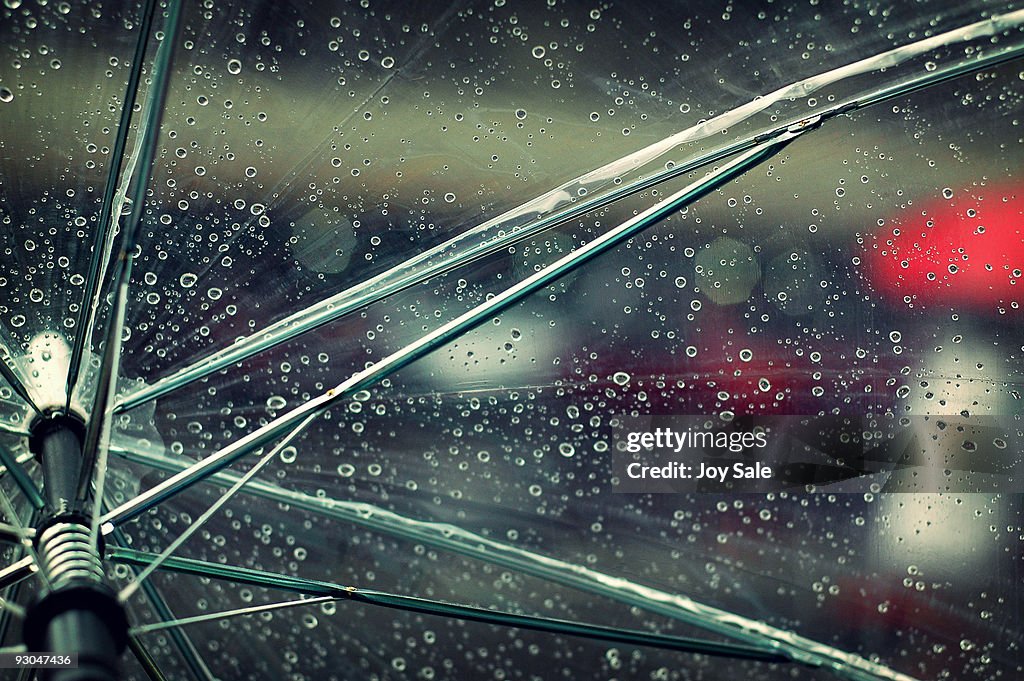 Raindrops and bokeh on transparent umbrella