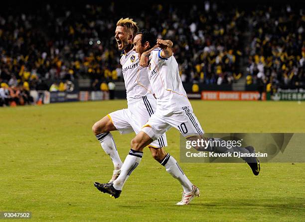 David Beckham and Landon Donovan of the Los Angeles Galaxy celebrate Donovan "s penalty goal against Houston Dynamo during the first half of the...