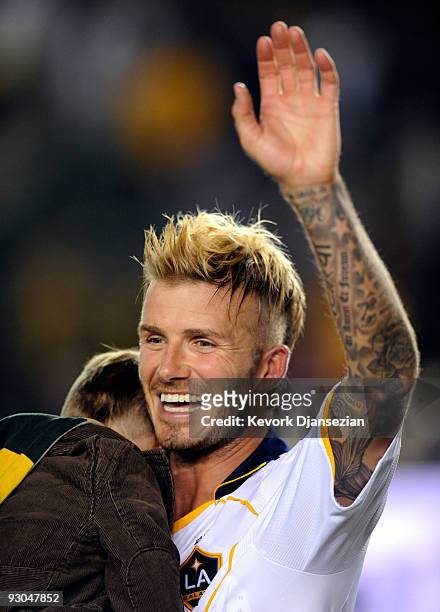 David Beckham of the Los Angeles Galaxy holding his son Cruz celebrates fater the Galaxy defeated Houston Dynamo, 2-0, during the MLS Western...