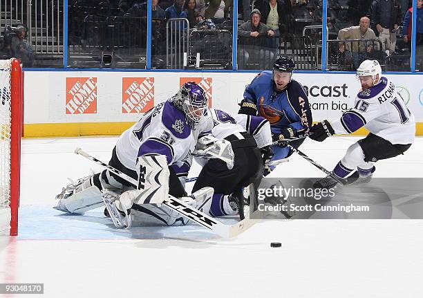 Erik Ersberg of the Los Angeles Kings looks to cover the puck against Todd White of the Atlanta Thrashers at Philips Arena on November 13, 2009 in...